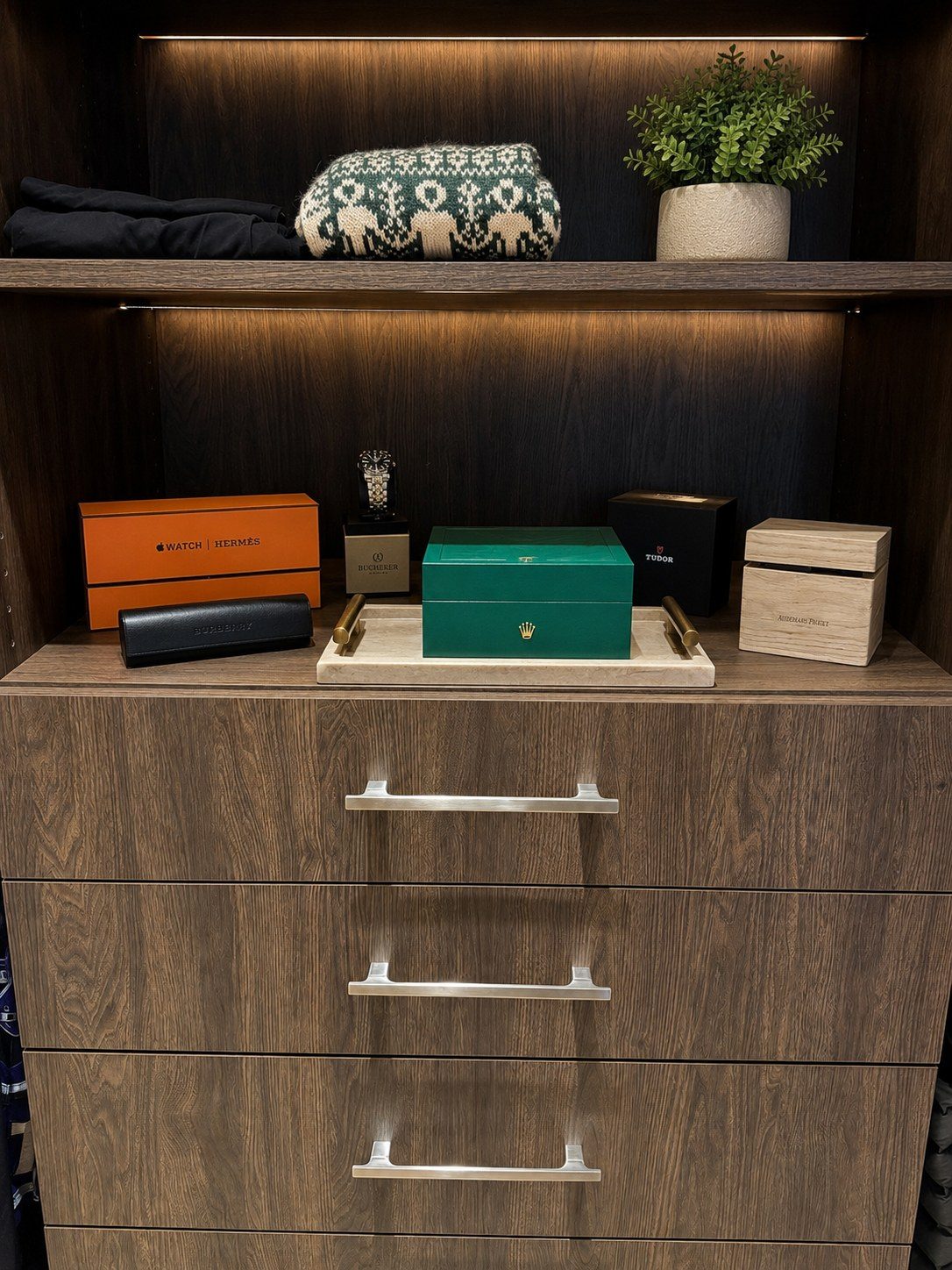 Organized closet with watches, accessories and folded clothing