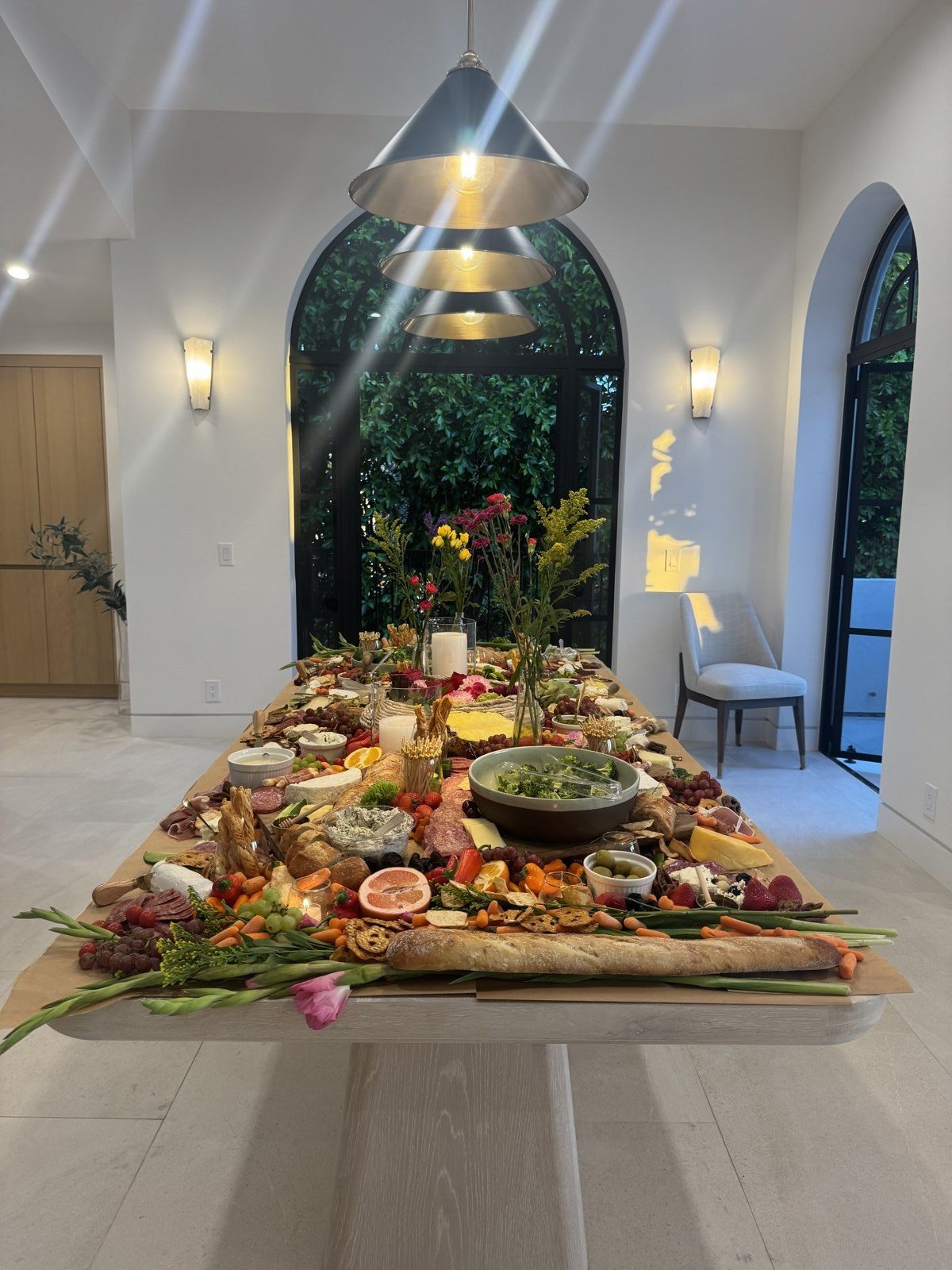 Elaborate grazing table and tablescape with candles and florals